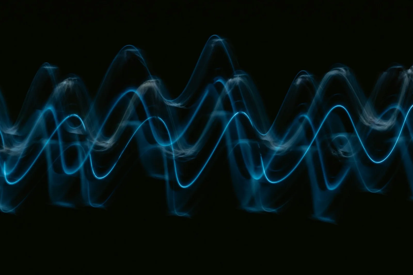 A blue wave of light against a black background